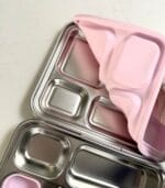Stack of Kaally Bento 4+ lunchboxes with pink lids, showing the compartment trays