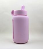 Kaally 500mL glass water bottle in dusty pink, wrapped in a protective silicone sleeve with a straw lid