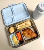 Blue-lid Bento 4+ packed with a croissant, carrot sticks, apple and dip, next to a Kaally water bottle