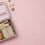 Kaally Bento 4+ stainless steel kids bento lunchbox, open and packed with a sandwich, apple, carrot and broccoli, on a soft pink background