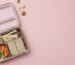 Kaally Bento 4+ stainless steel kids bento lunchbox, open and packed with a sandwich, apple, carrot and broccoli, on a soft pink background