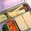 Kaally stainless steel bento lunch box with lilac lid packed with sandwiches, apple, carrots and snacks