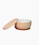 Beige porcelain baby bowl with silicone suction sleeve and matching lid