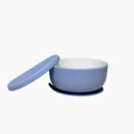 Blue porcelain baby bowl with silicone suction sleeve and matching lid