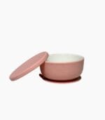 Pink porcelain baby bowl with silicone suction sleeve and matching lid