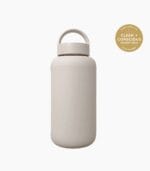 Kaally Glass Sports Bottle in Almond with the Clean + Conscious Awards 2026 Gold Winner rosette, Best Reusable Bottle / Cup