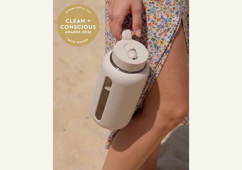Kaally Glass Bottle in Almond with the Gold rosette — Best Reusable Bottle / Cup, Clean + Conscious Awards 2026